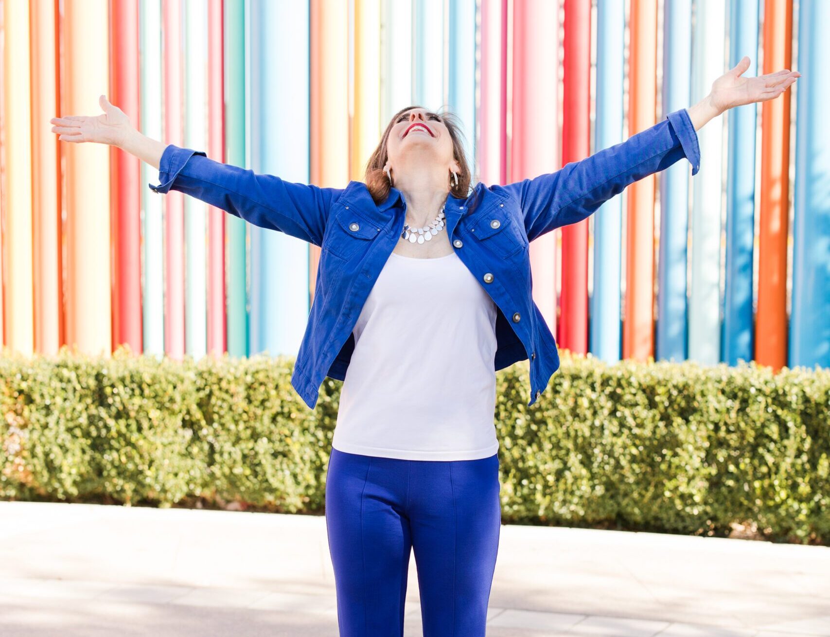 Maureen posing outside in a vibrant blue suit