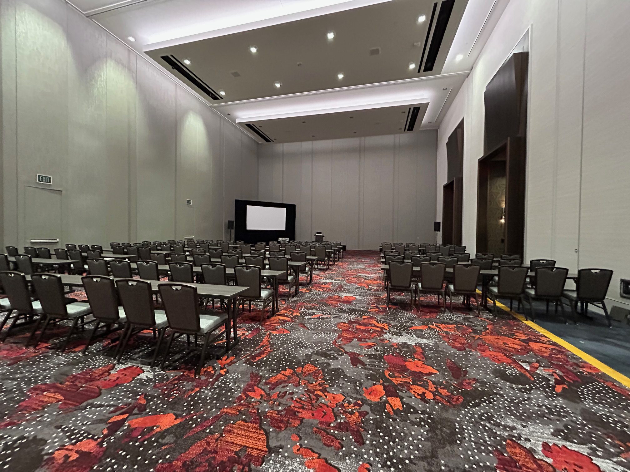 Empty conference room with chairs facing a screen, ready for an event. The empty seats that mattered.