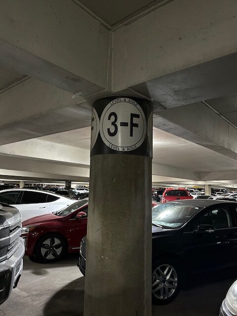 Parking garage level 3-F sign on a concrete pillar. Navigating parking with bravado and breadcrumbs.