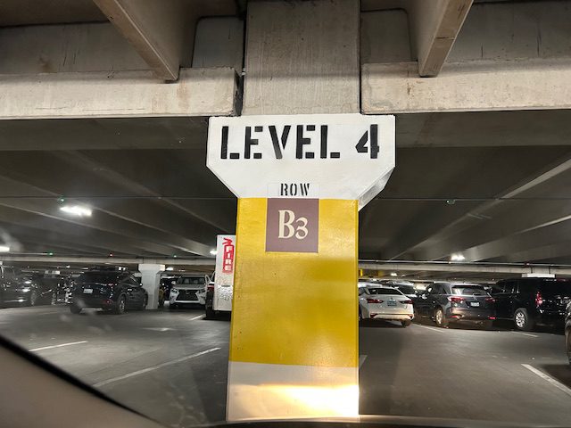 Parking garage sign: Level 4, Row B3.
