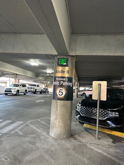 Parking garage aisle B, level 5 for Terminal 1 public parking with cars.