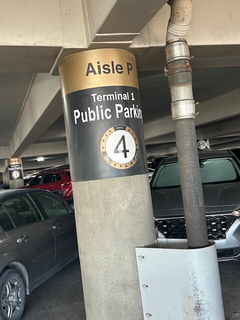 Parking garage sign: Aisle P, Terminal 1 Public Parking, Level 4.