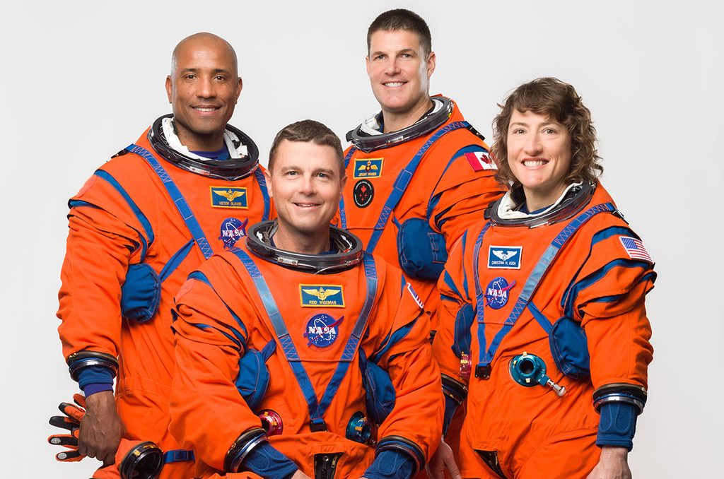 NASA Artemis II astronauts in orange spacesuits before the historic crewed Moon mission