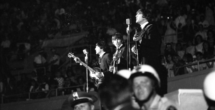 The Beatles perform at the Las Vegas Convention Center in August 1964 with police stationed in front of the stage.