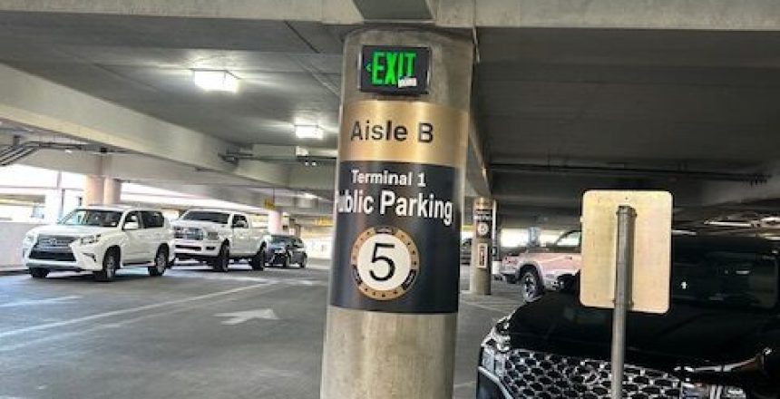 Parking garage aisle B, level 5 for Terminal 1 public parking with cars.
