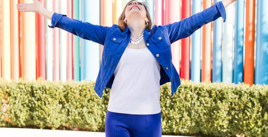 Maureen posing outside in a vibrant blue suit